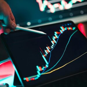 Close-up of cryptocurrency trading analysis on a digital tablet, highlighting market trends.